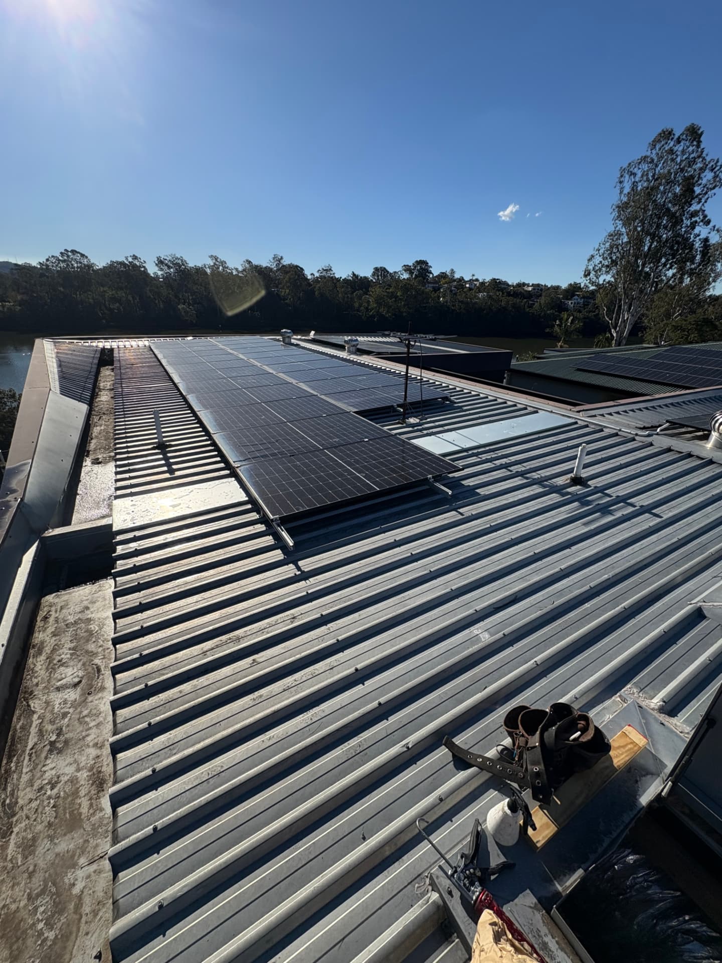 Wide view of the completed Yeronga roof repair with the river in the background