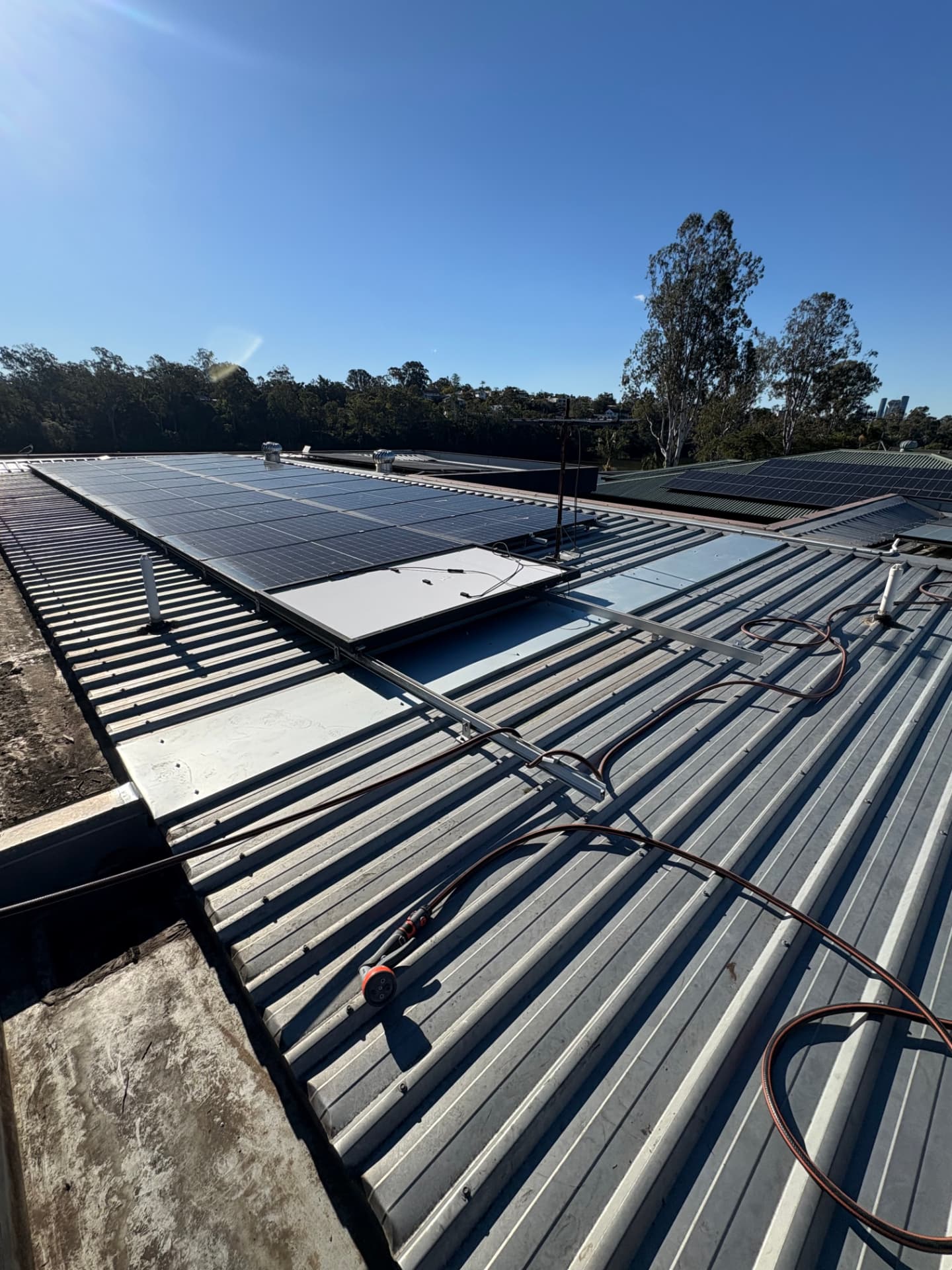 Completed metal roof with solar panels overlooking the Brisbane River at Yeronga